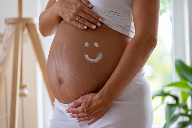 Close,Up,Of,Pregnant,Belly,With,Smiley,Drawn,With,Moisture Close,Up,Of,Pregnant,Belly,With,Smiley,Drawn,With,Moisture
