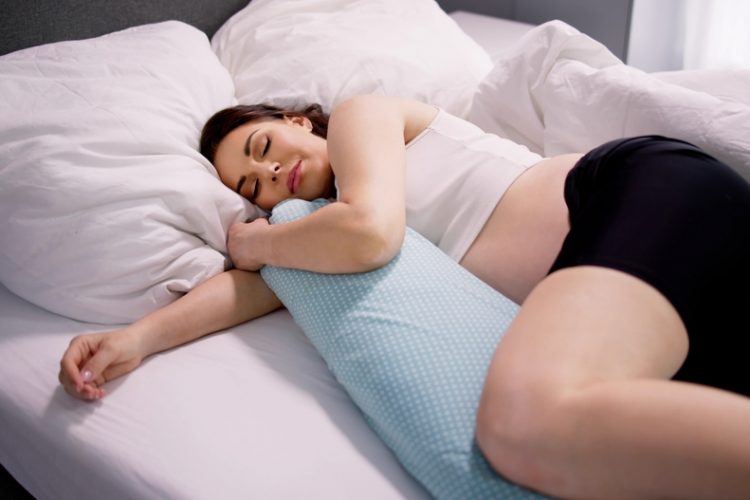 Pregnant,Woman,Sleeping,On,Bed,With,Special,Pillow