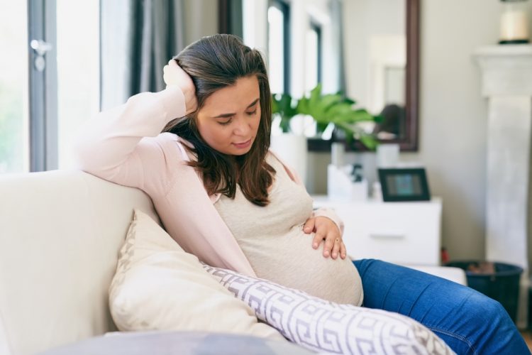 Pregnancy,,Woman,And,Tired,On,Sofa,In,Home,,Physical,And