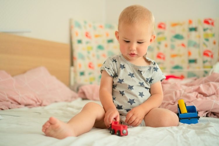 Cheerful,Baby,In,Star-patterned,Romper,Joyfully,Plays,With,A,Red Cheerful,Baby,In,Star-patterned,Romper,Joyfully,Plays,With,A,Red