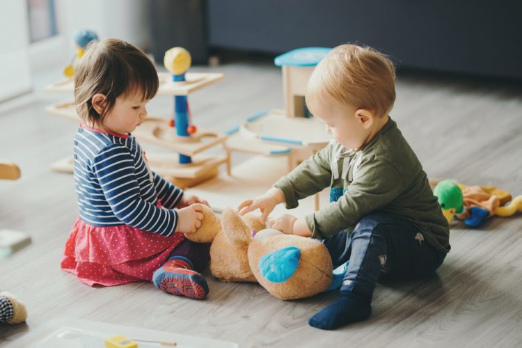 Cute,Little,Girl,And,Boy,Playing,With,Toys,By,The